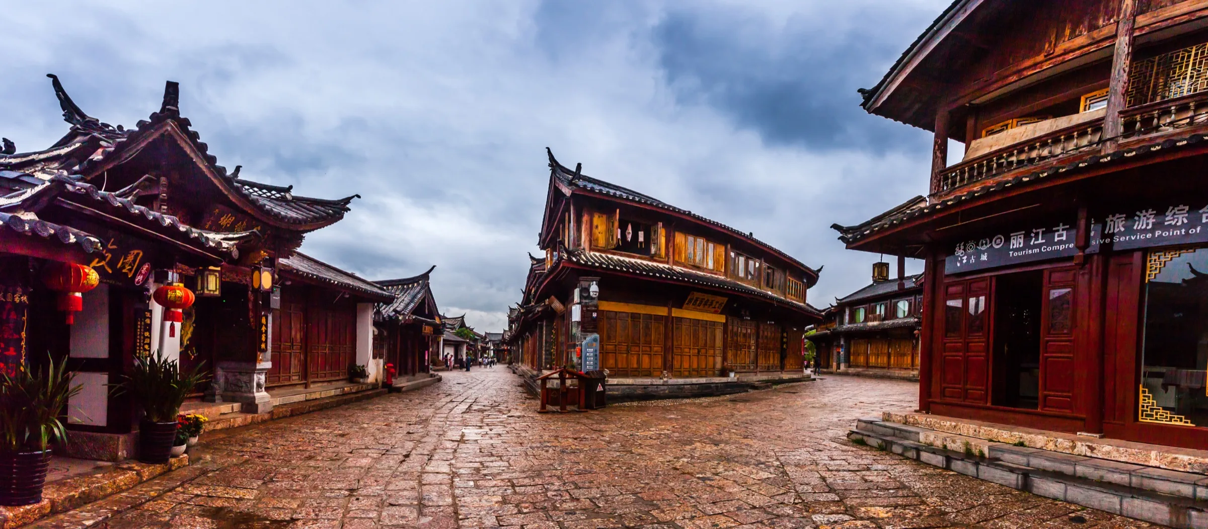 Wet stone lanes and timber buildings in Lijiang Old Town after rain