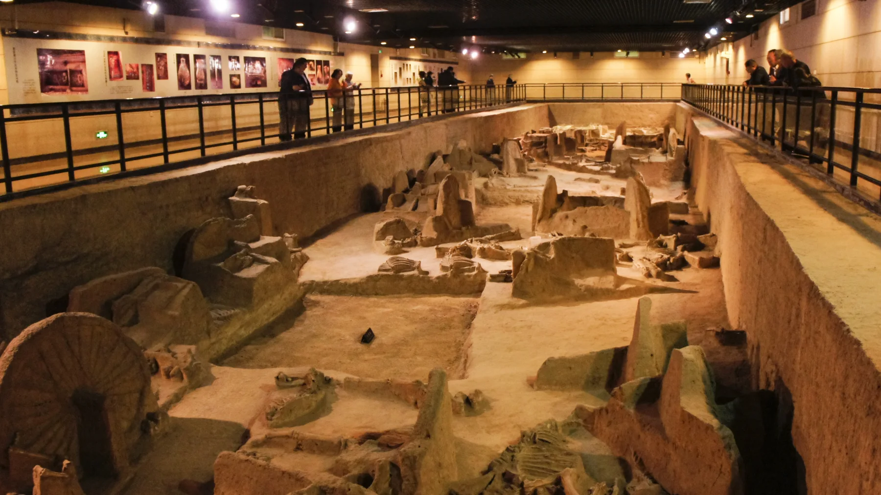 Excavated chariots and horse remains displayed inside the Tianzi Jialiu museum