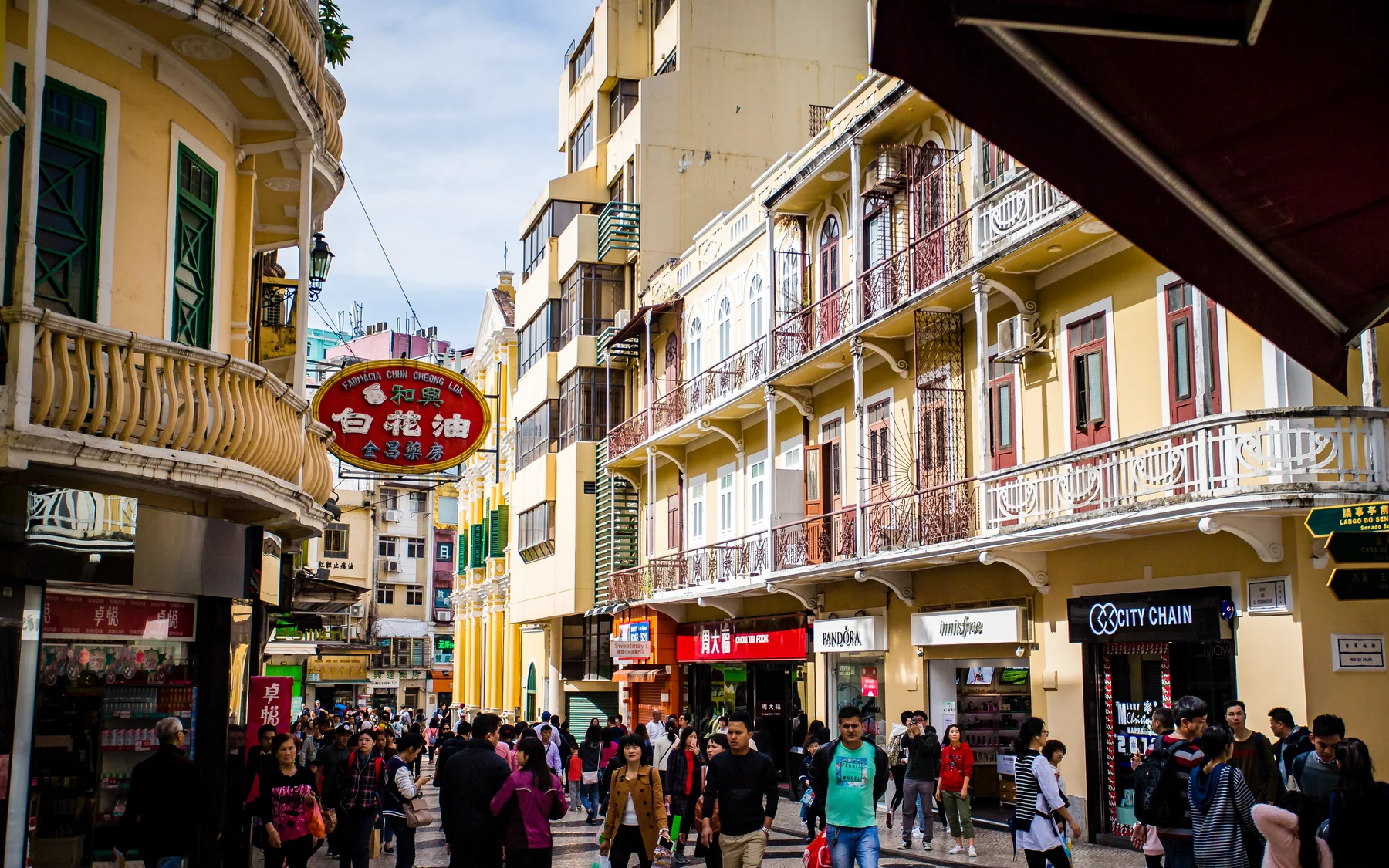 A Macau commercial lane where tourism, neighborhood trade and heritage share the same pavement