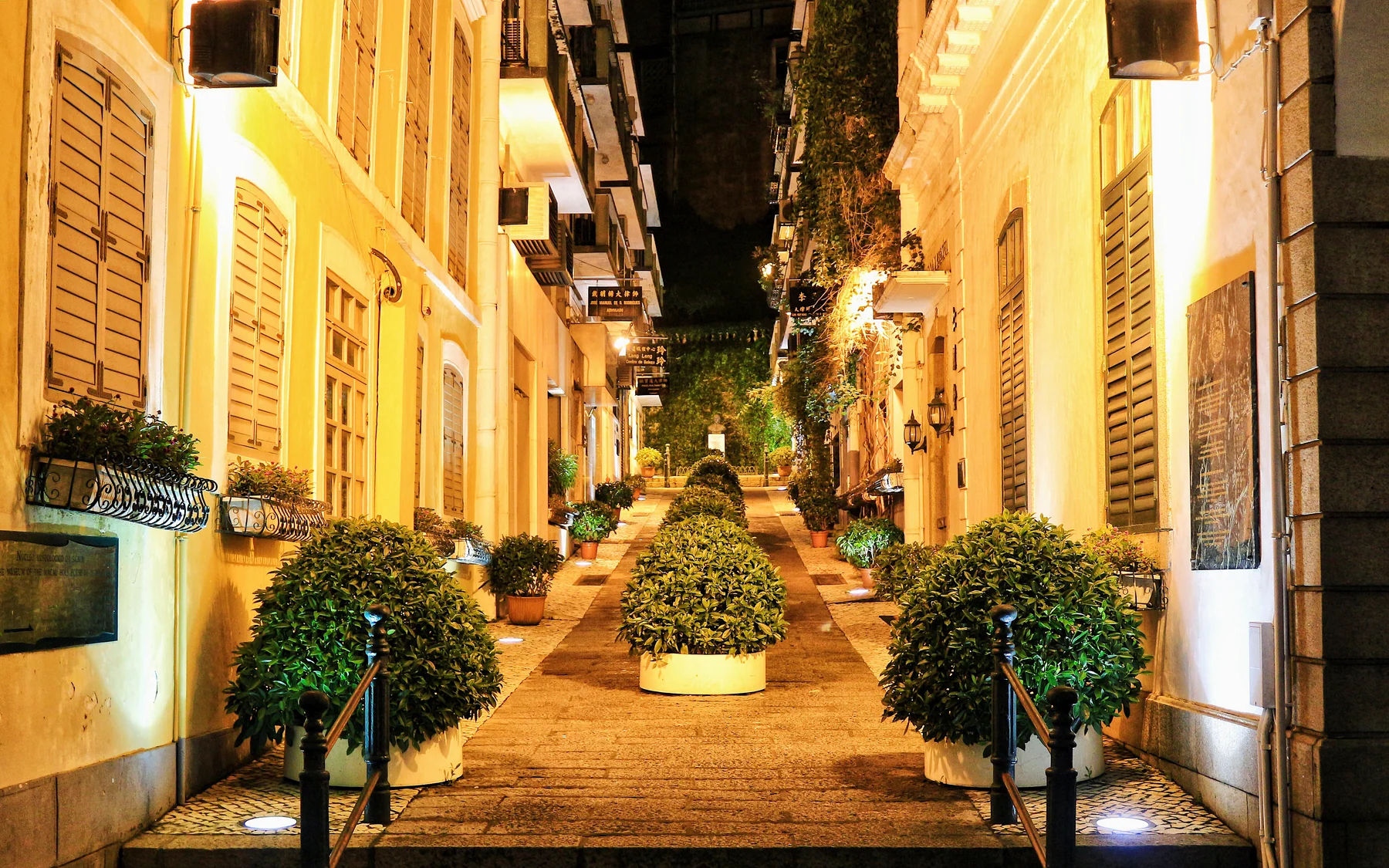 Macau historic centre at night, with heritage streets and the working city beyond
