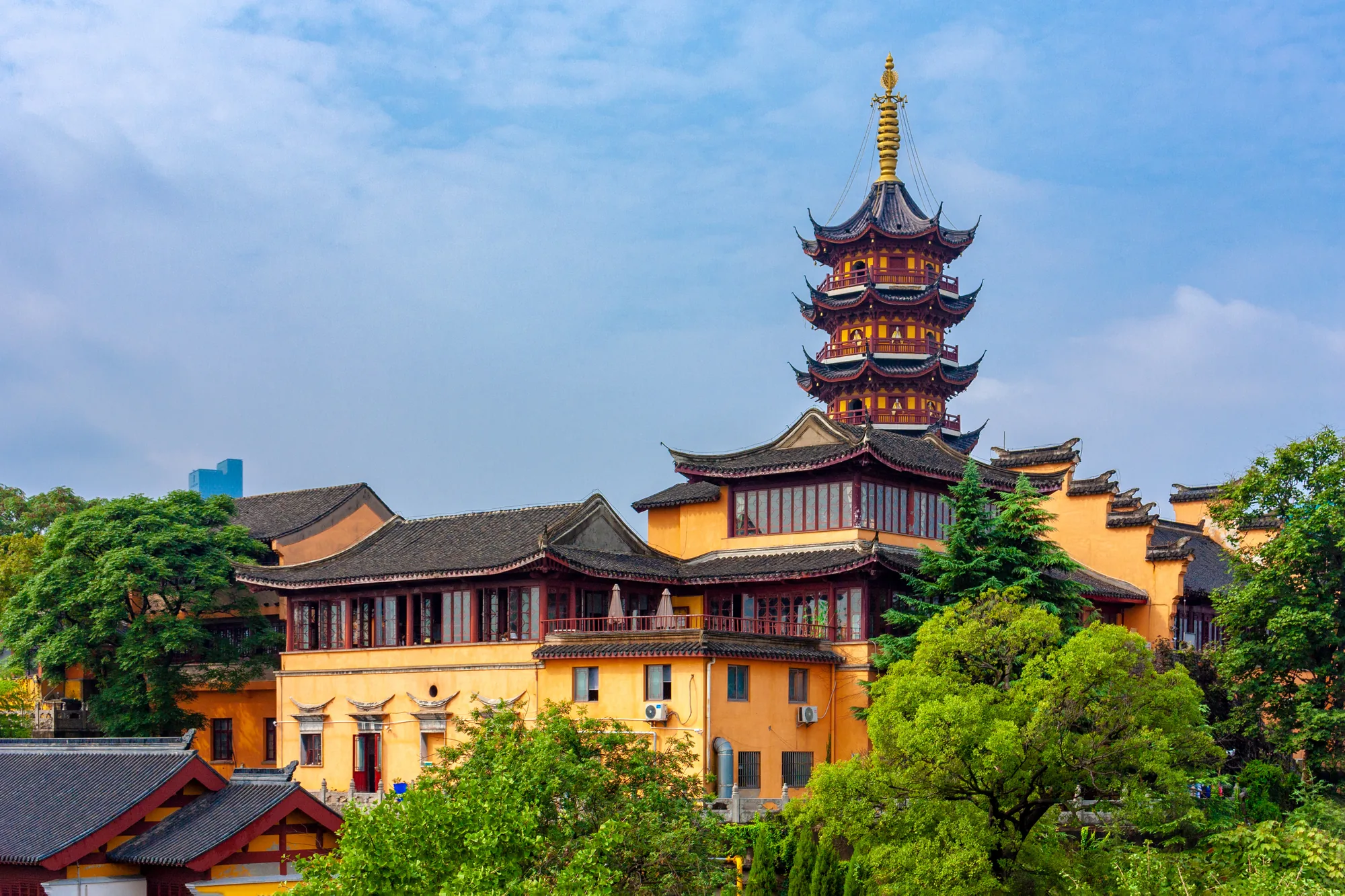 A quieter courtyard with yellow walls inside Jiming Temple