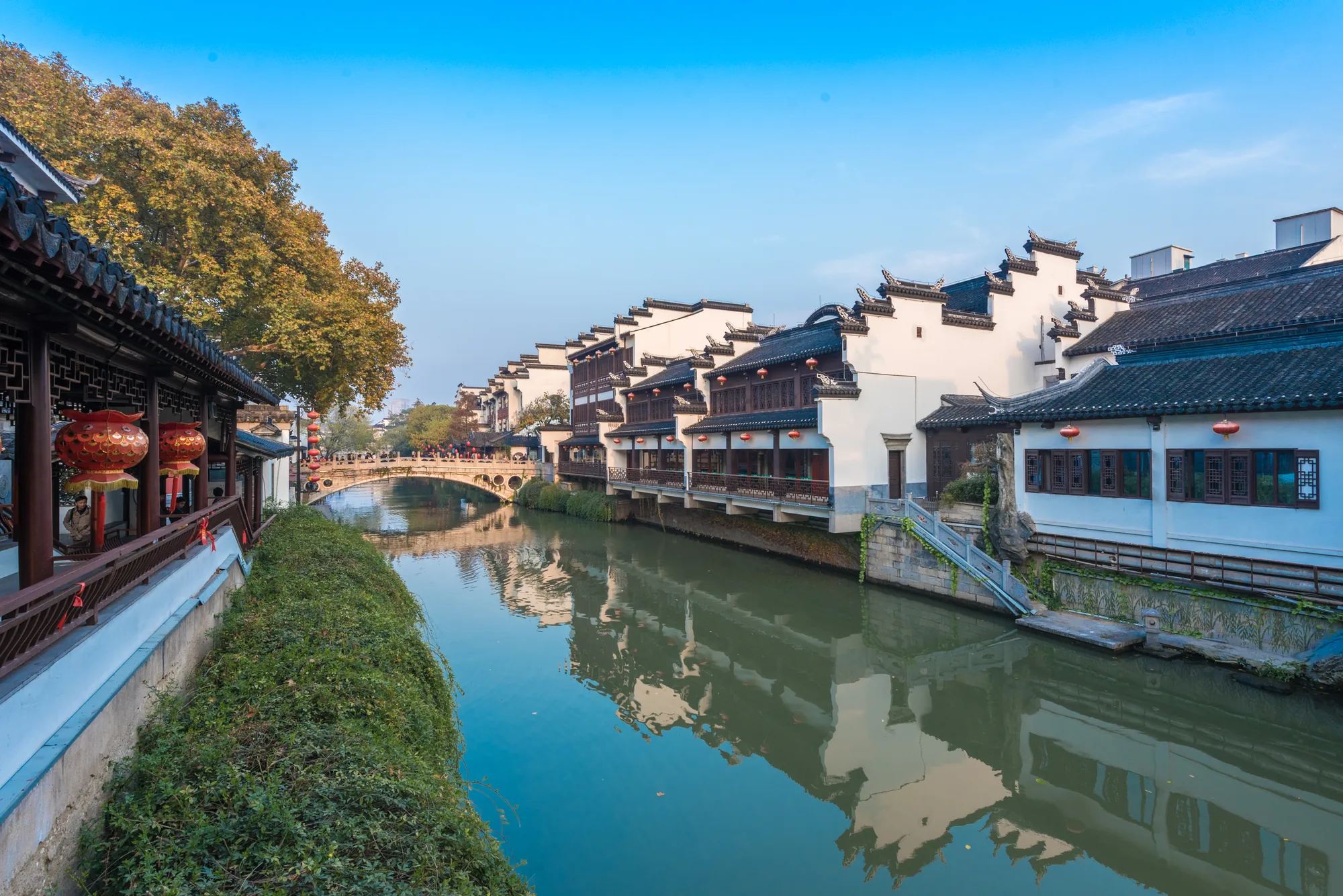 Qinhuai River, traditional-style waterside buildings and modern Nanjing seen in daylight
