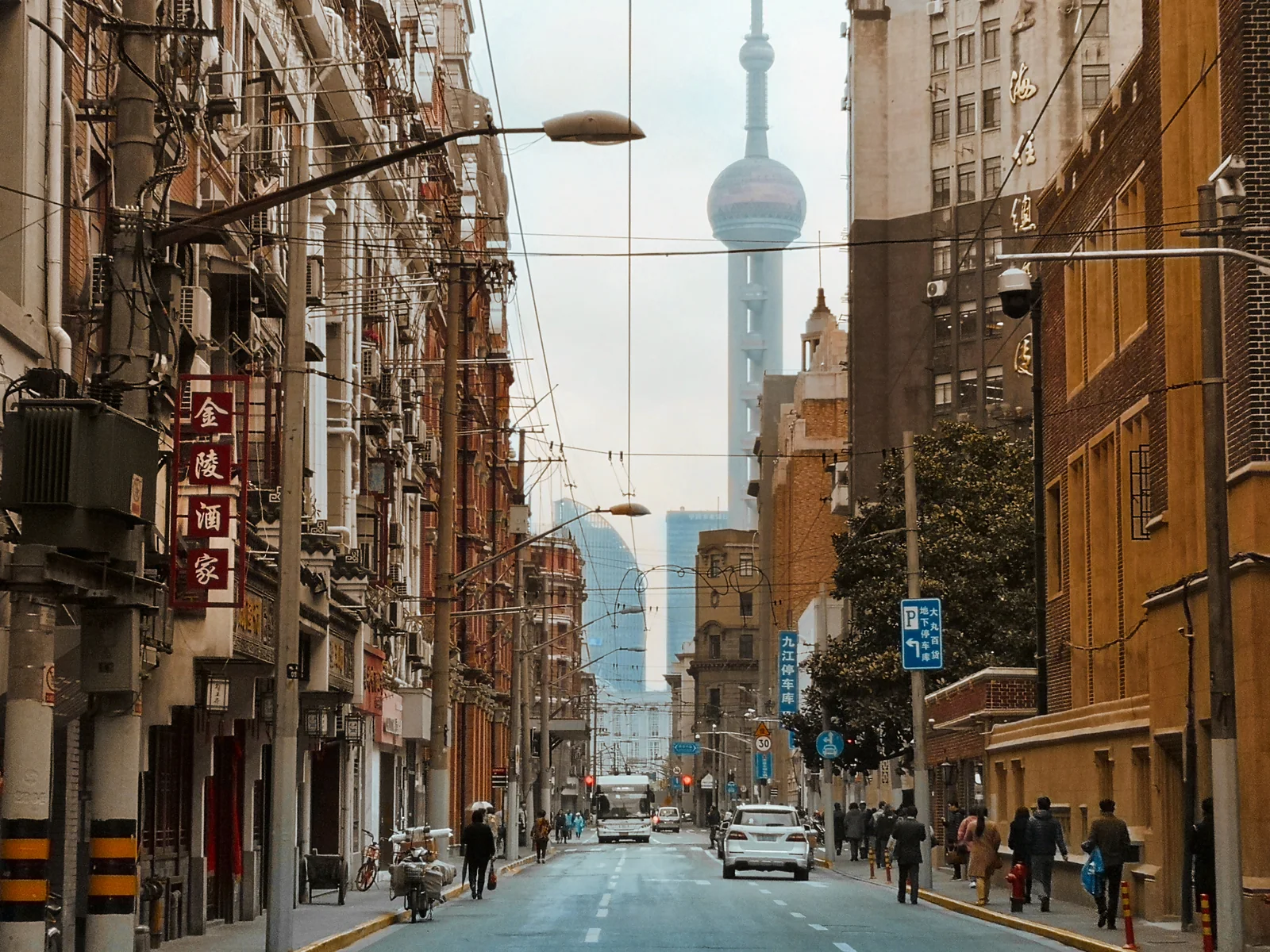 Historic Bund facades, a working road and the Oriental Pearl Tower sharing one Shanghai street view