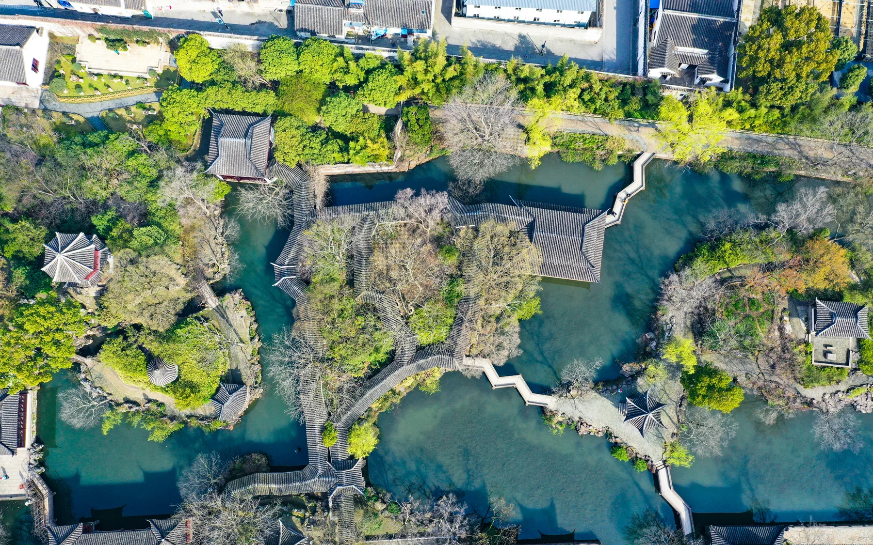 Aerial view of Humble Administrator's Garden showing water, bridges, halls and the dense city edge around a designed landscape