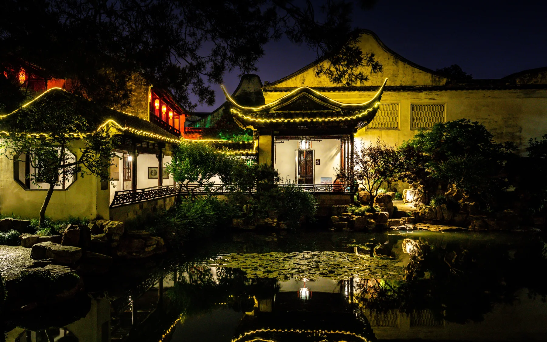 Master of the Nets Garden at night, showing how lighting changes the scale and intimacy of a small Suzhou garden