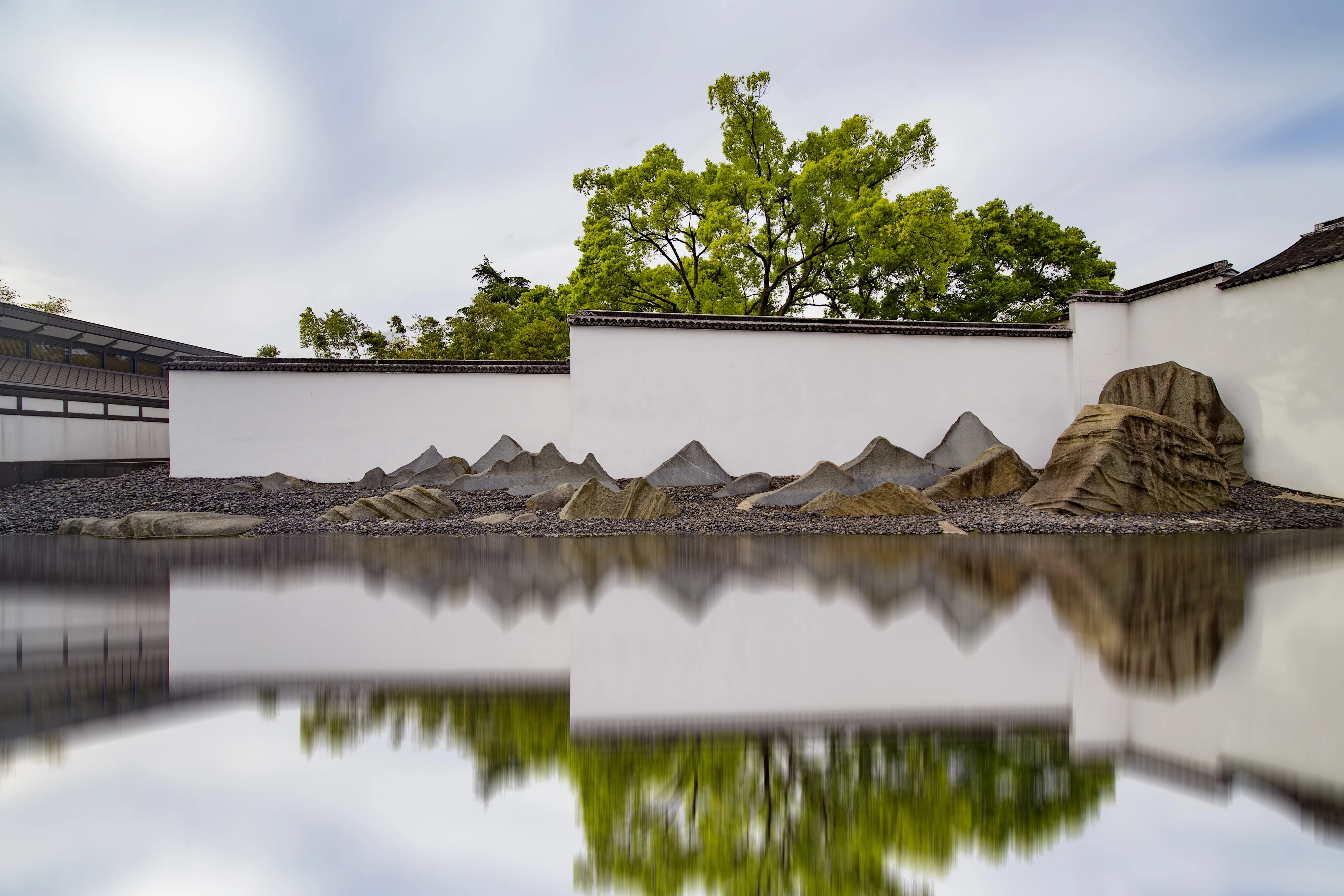 White walls, abstract stone mountains and a reflecting pool at Suzhou Museum