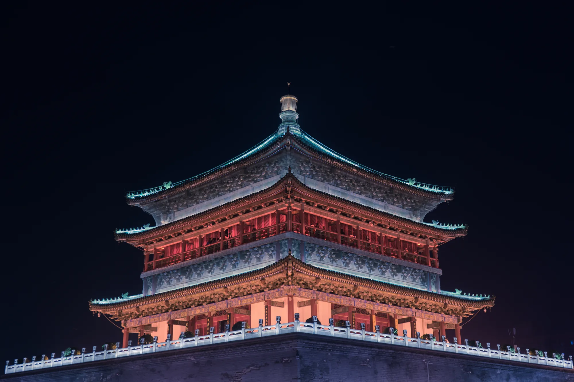 Close night view of the illuminated Bell Tower against a dark sky