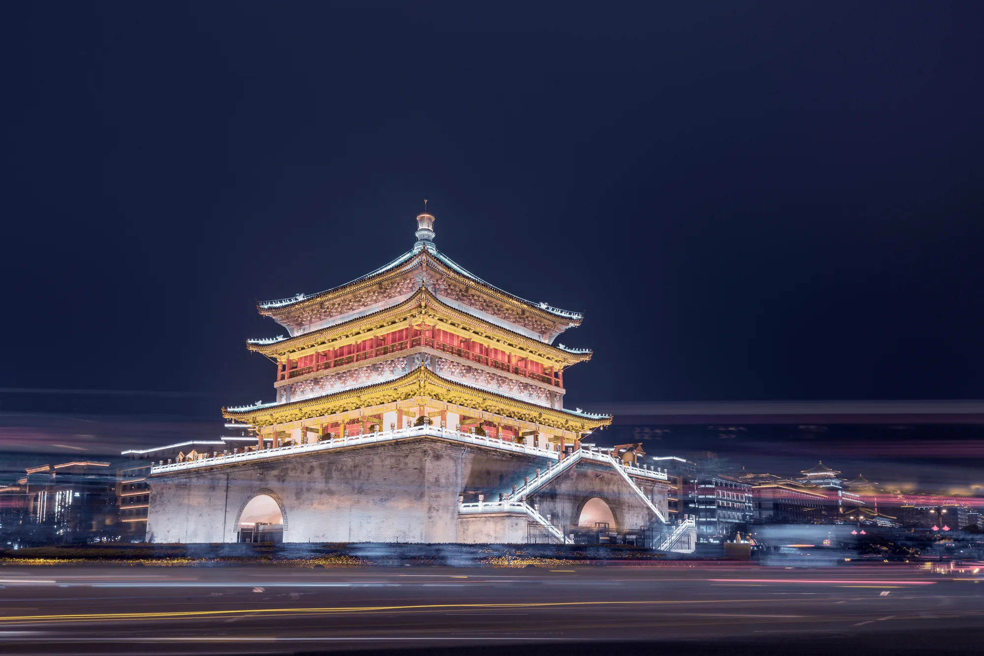 The Drum Tower illuminated above evening traffic and the Muslim Quarter area
