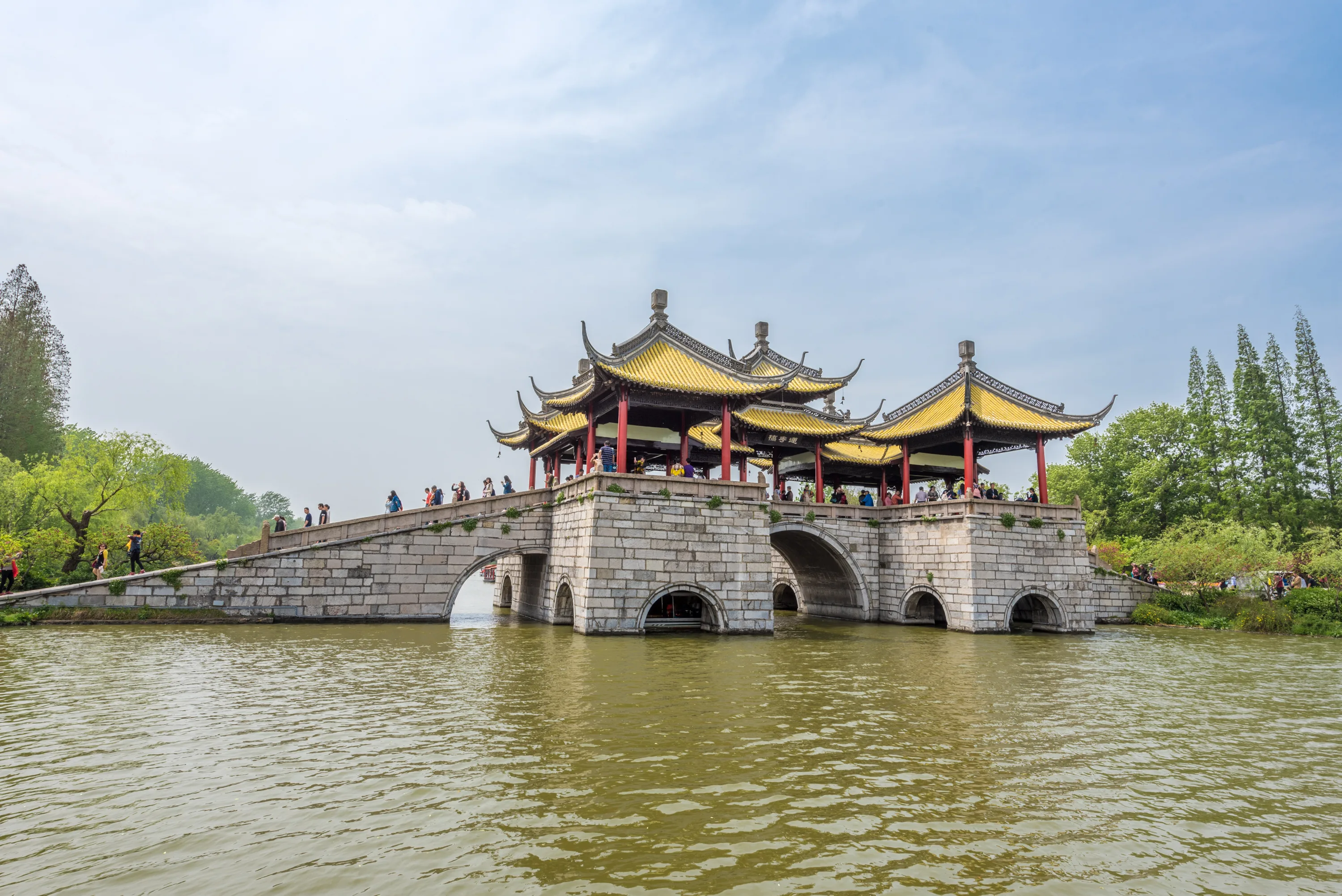 Five Pavilion Bridge crossing the landscaped water of Slender West Lake in springtime Yangzhou