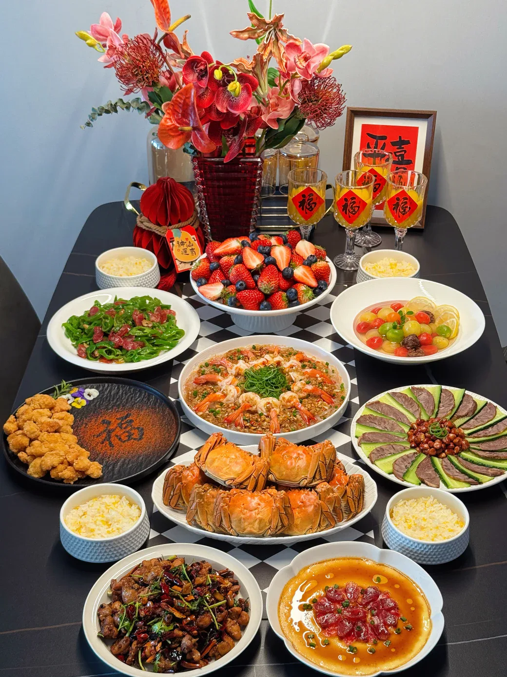 A Chinese New Year family table filled with seafood, meat, vegetables, fruit and individual rice bowls