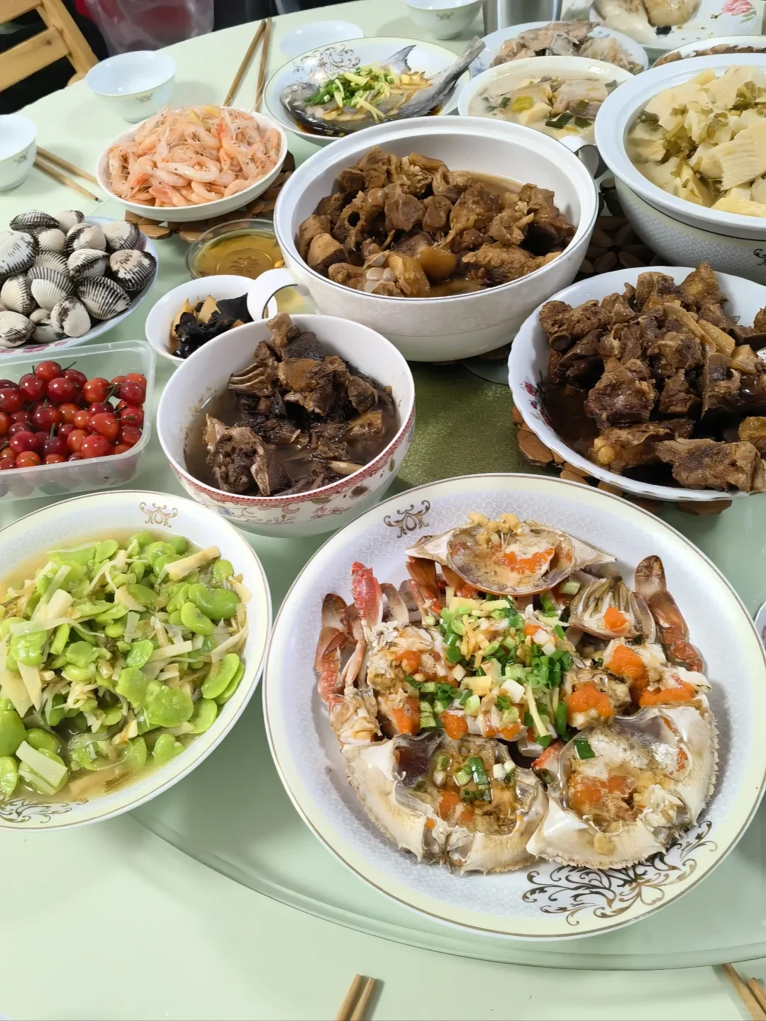 Fish, shellfish, meat and spring vegetables covering a family table after Qingming