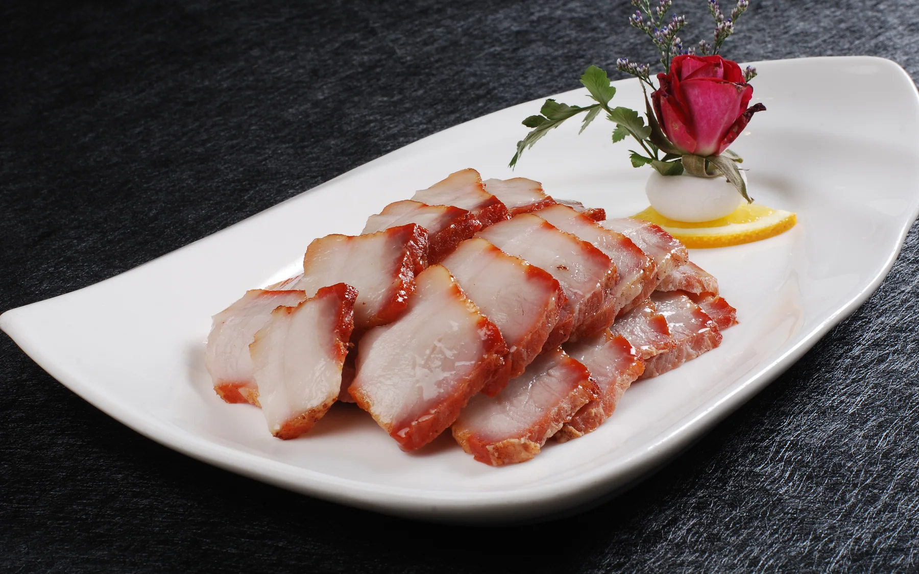 Cantonese char siu showing caramelized edges without losing interior moisture