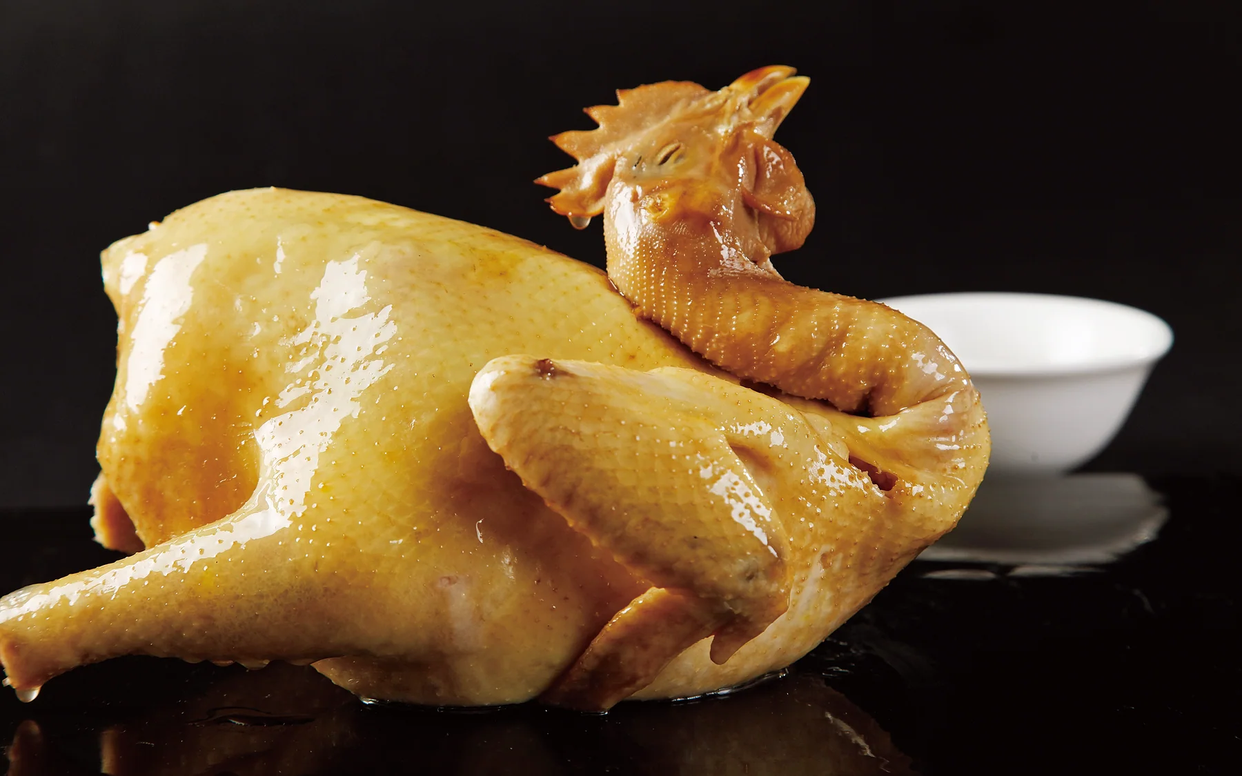 Qingyuan white-cut chicken whose pale skin and clean cut make doneness visible