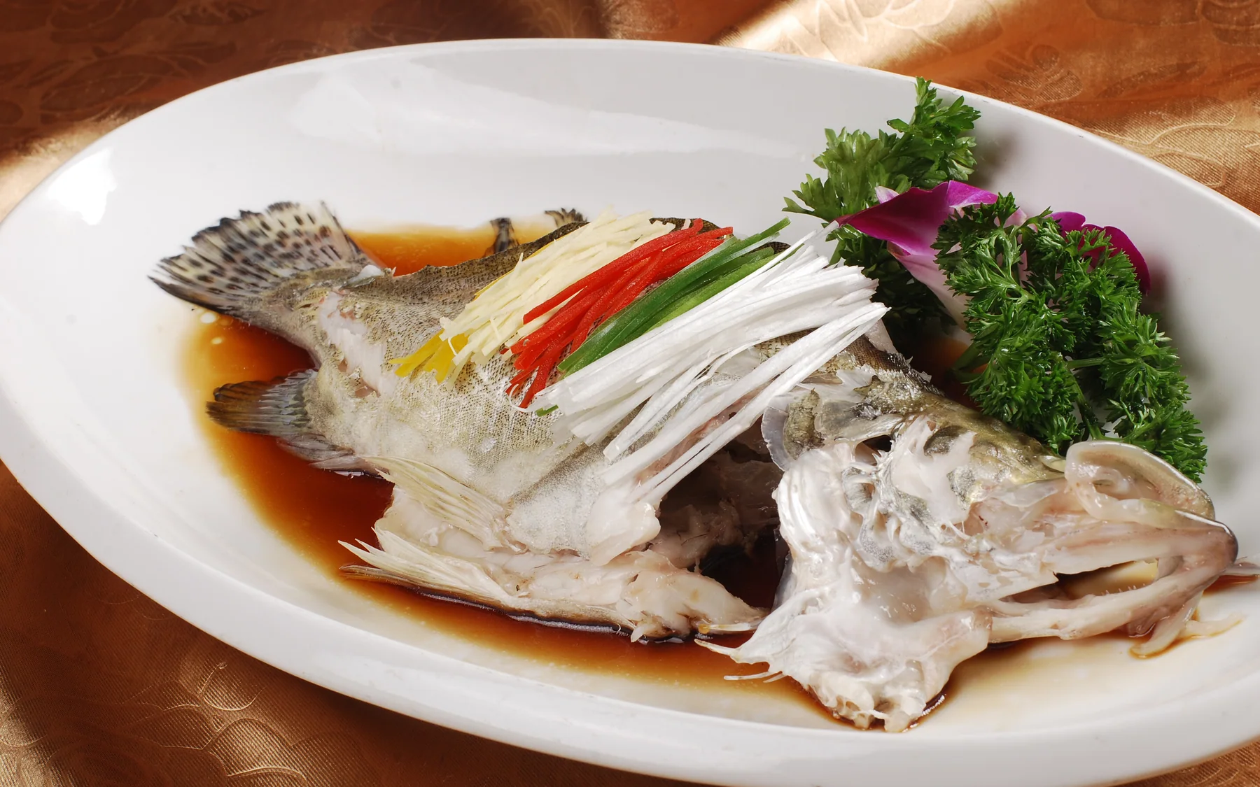 Whole steamed mandarin fish showing Cantonese timing, moisture and finishing aromatics