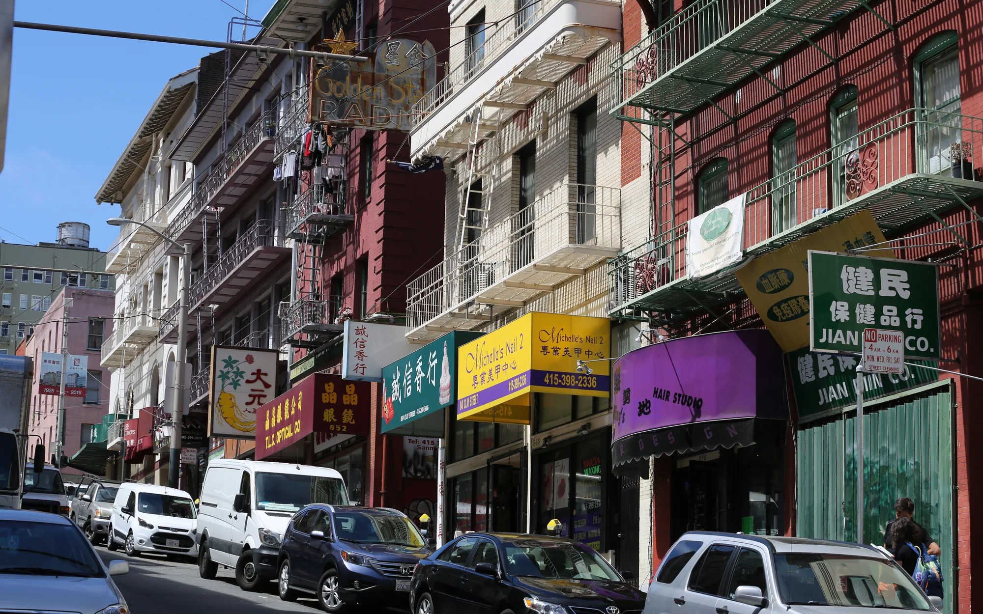 Chinese-language shops, restaurant signs and apartment fire escapes on a San Francisco Chinatown street