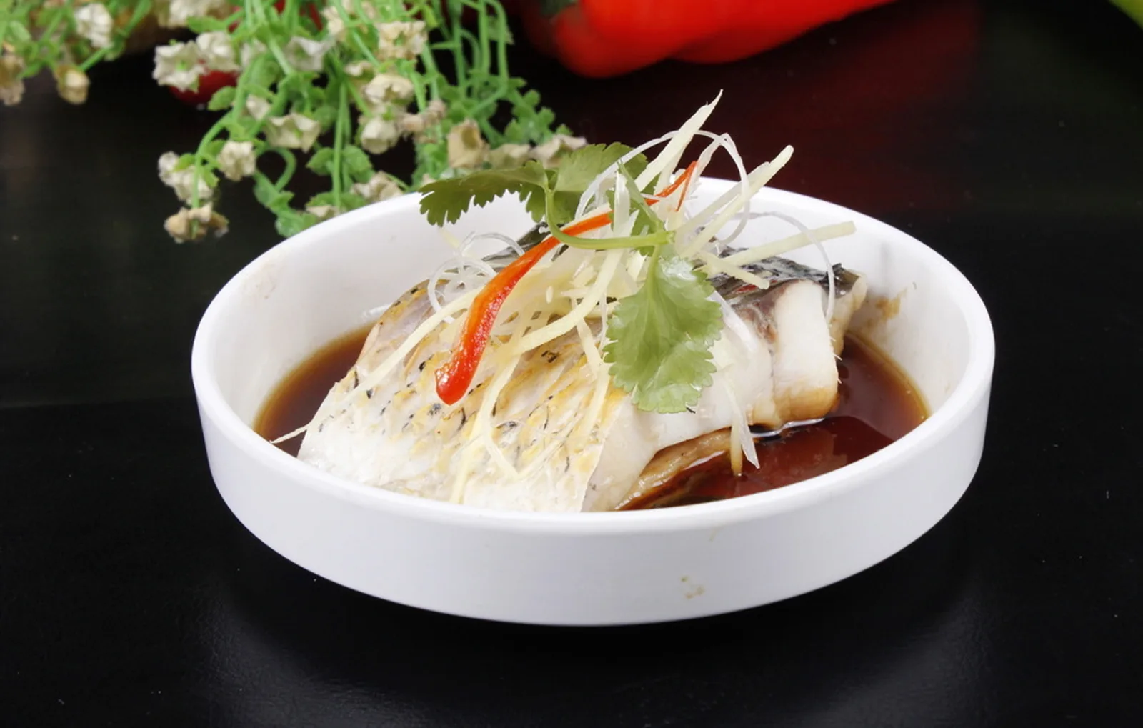 Chinese steamed fish with ginger and scallions representing food in Oceania
