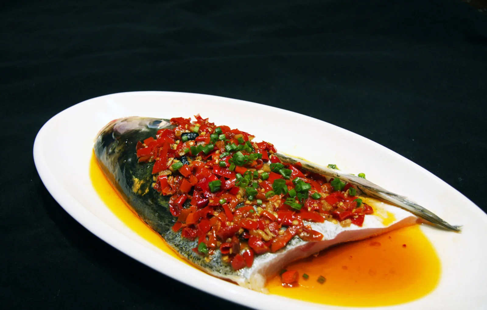 Hunan steamed fish head covered with chopped red chilies