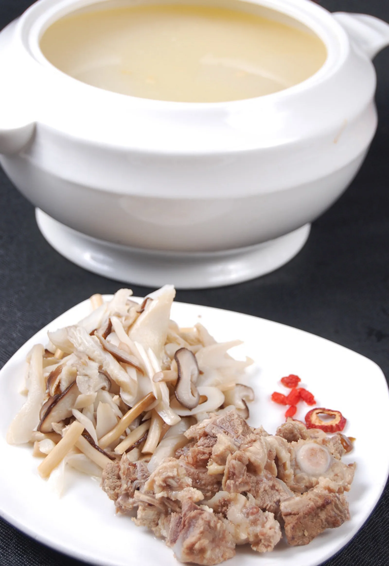 Chinese chicken and wild mushroom soup in a ceramic bowl