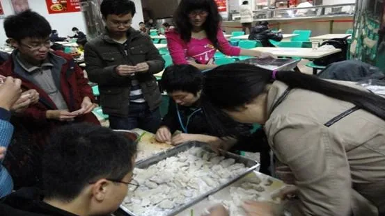 People making Chinese dumplings together as part of Chinese food culture and history