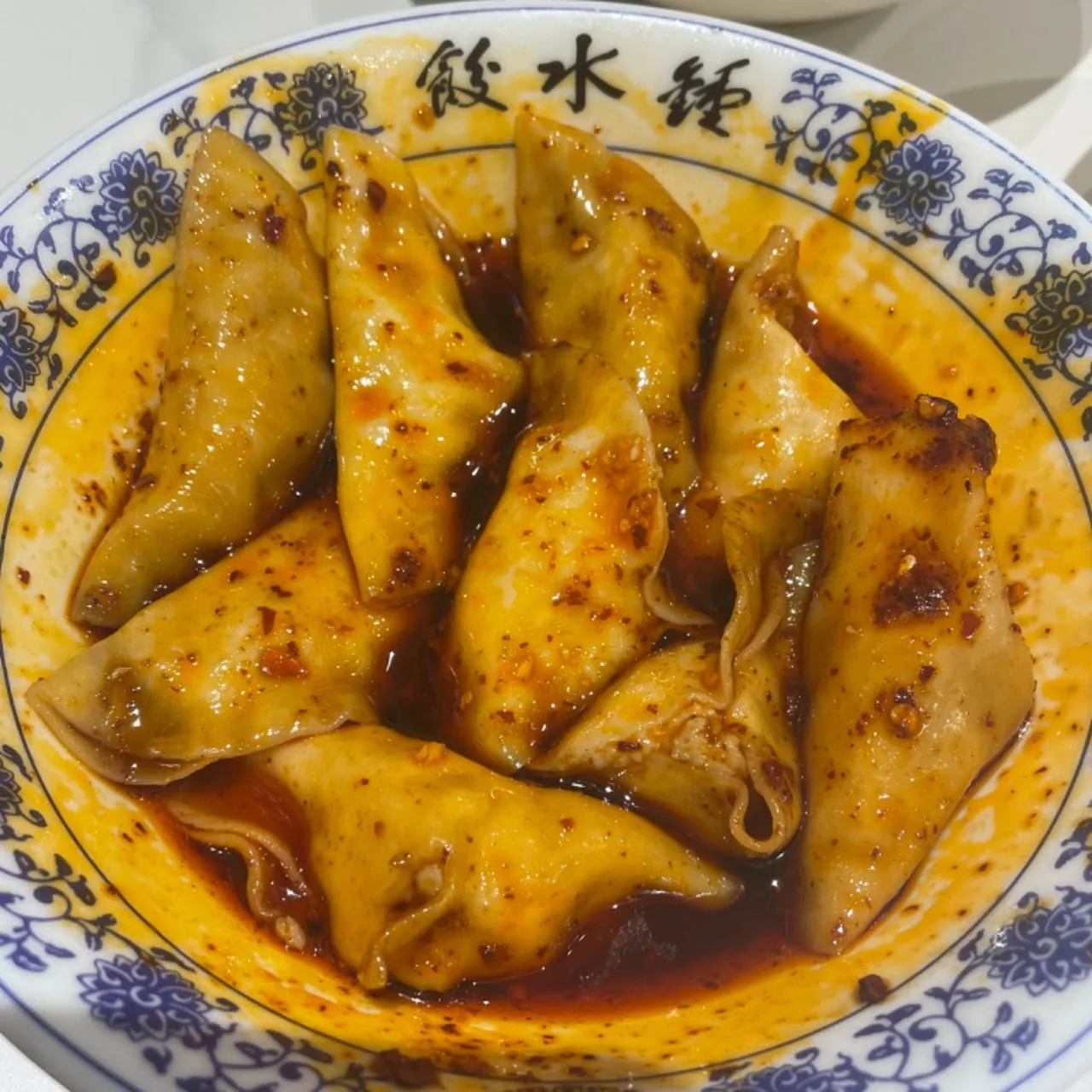 Chinese dumplings served as Chengdu Zhong shui jiao with red chili oil and garlic