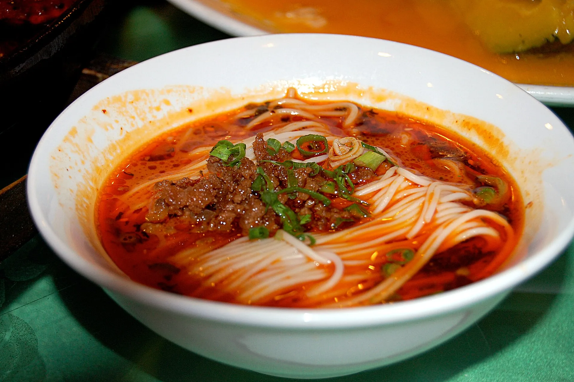 Chinese noodles served as dan dan noodles with chili oil and minced meat