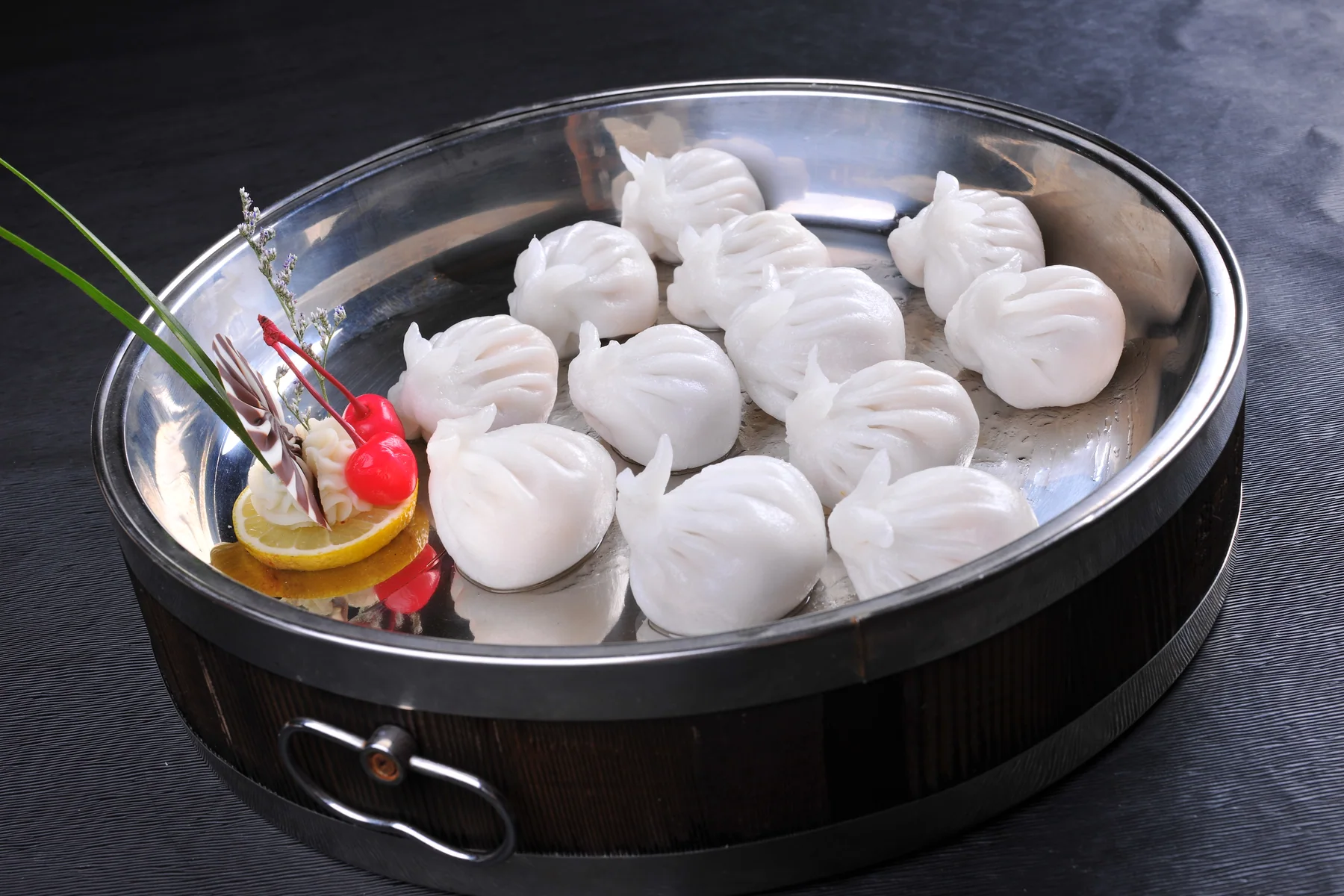 White rabbit-shaped crystal dumplings arranged in a metal steamer tray