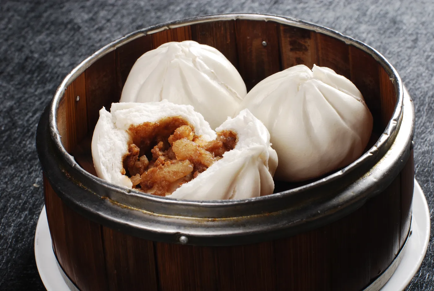 Steamed char siu buns opened to show roast-pork filling