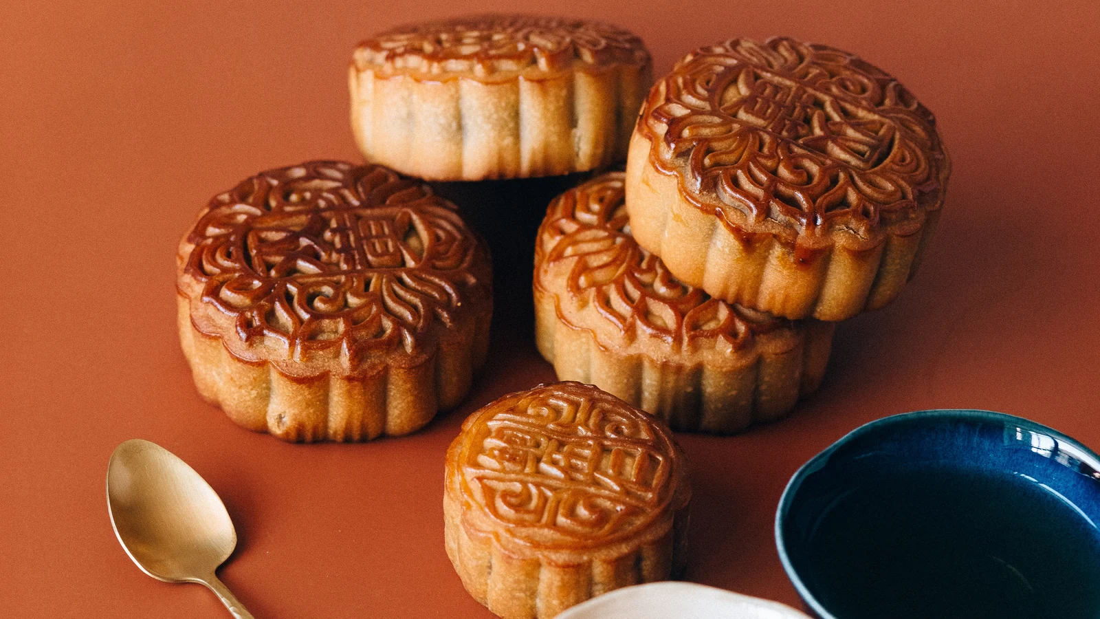 Mooncakes with tea on a table, photographed for East Moment's mooncake guide