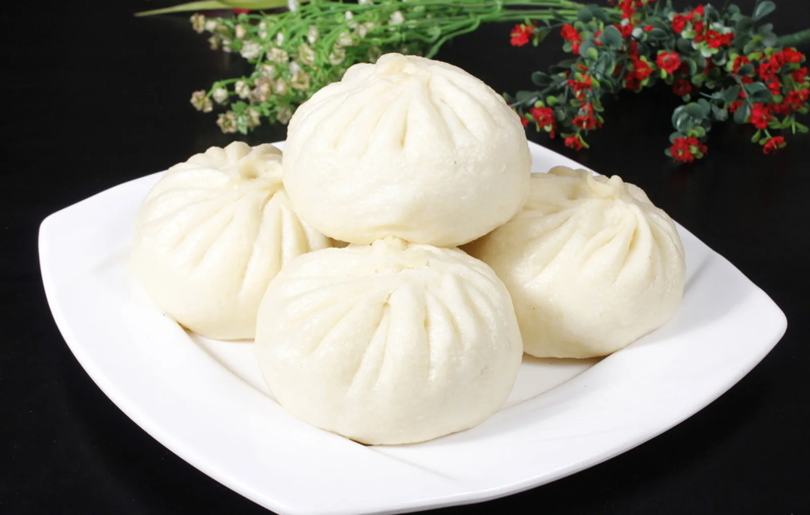 Beijing food represented by steamed baozi with softly pleated wheat-flour wrappers