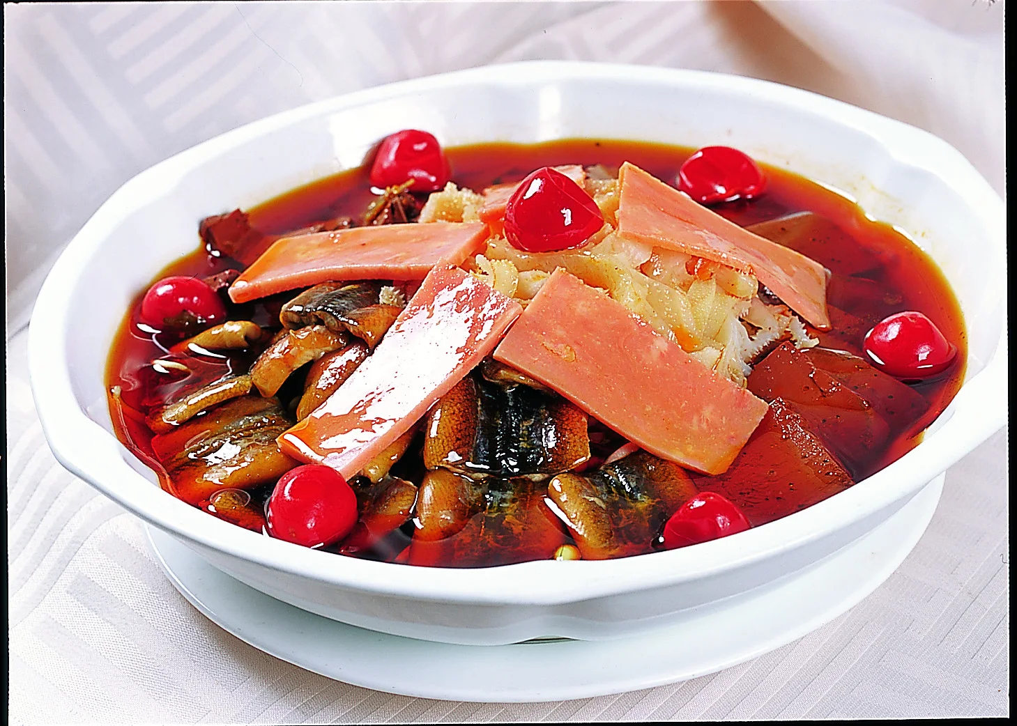A bowl of Chongqing maoxuewang showing mixed ingredients held together by a red aromatic broth