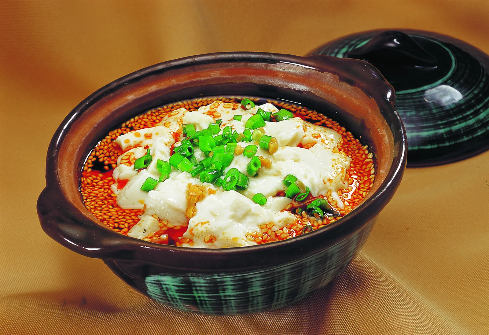 Soft douhua topped with scallion and a chile-rich savory condiment