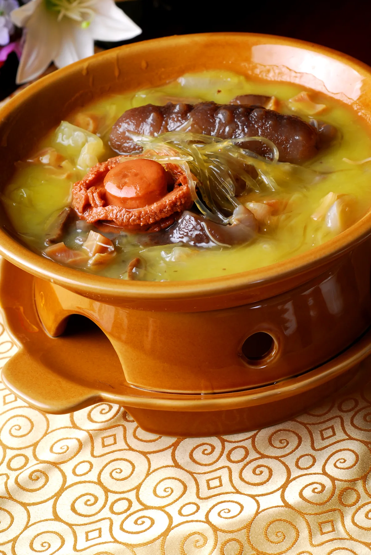 Fujian cuisine banquet dish Buddha Jumps Over the Wall with abalone, sea cucumber and broth