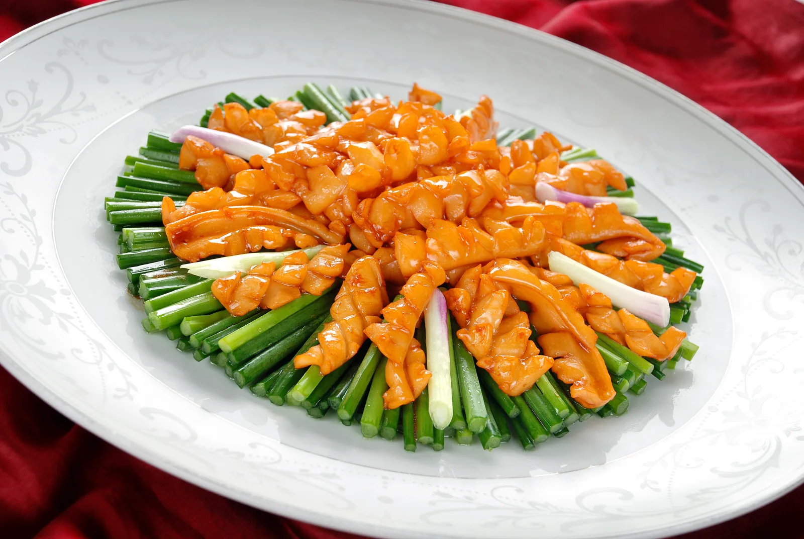 Fujian coastal seafood represented by scored squid served over fresh chives