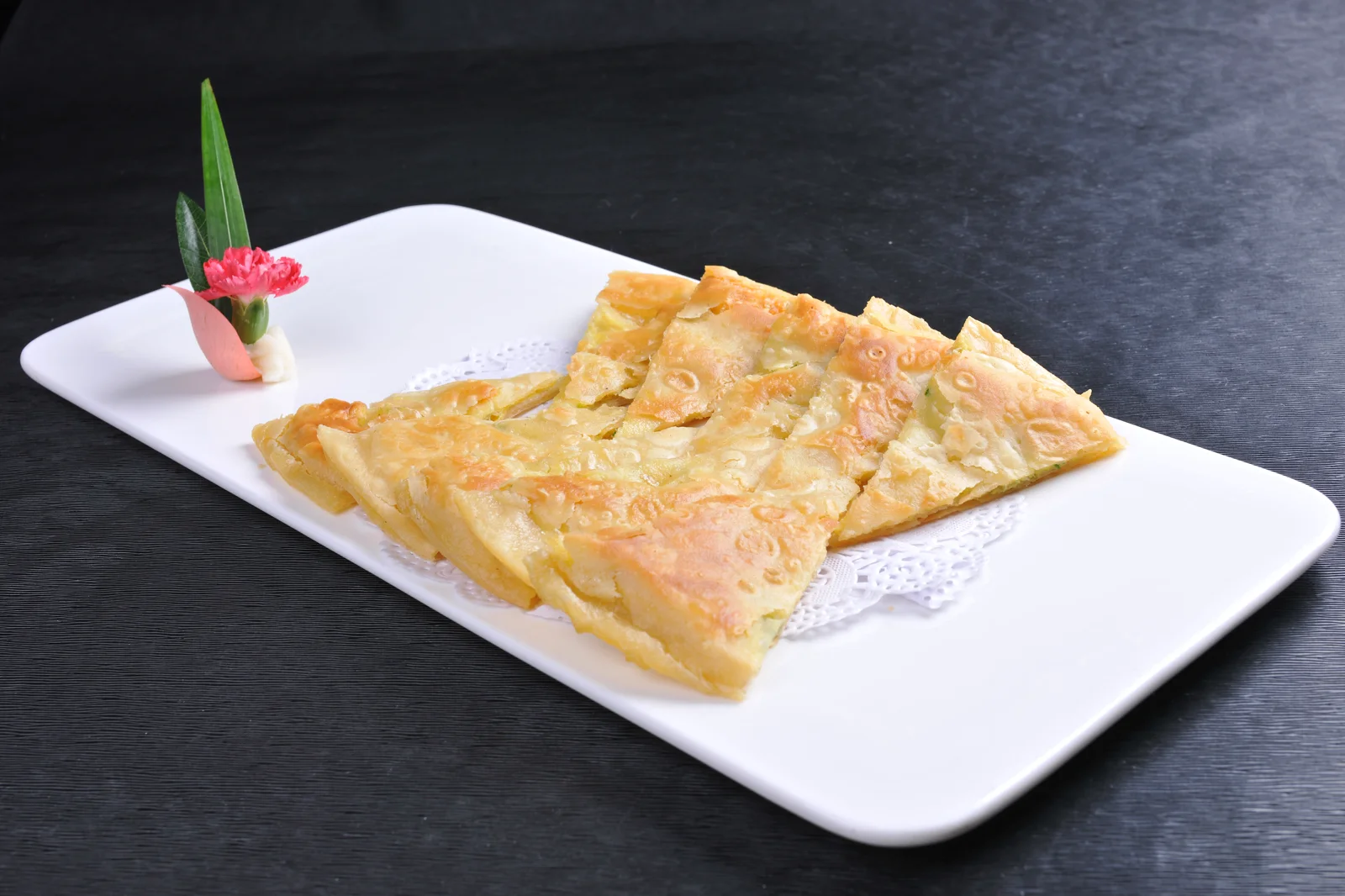 A thin egg-filled wheat pancake cut into crisp golden squares