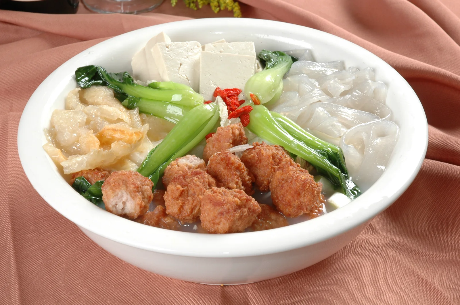A bowl of Henan mixed stew with meatballs, tofu, greens and vermicelli