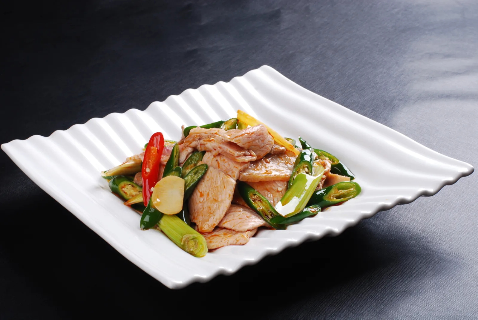 Hunan cuisine served as stir-fried pork with fresh green and red chilies