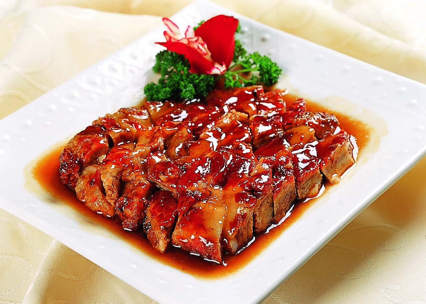 Glossy sweet-savory pork ribs showing sauce reduction as a technique that must be balanced by rice, greens and broth