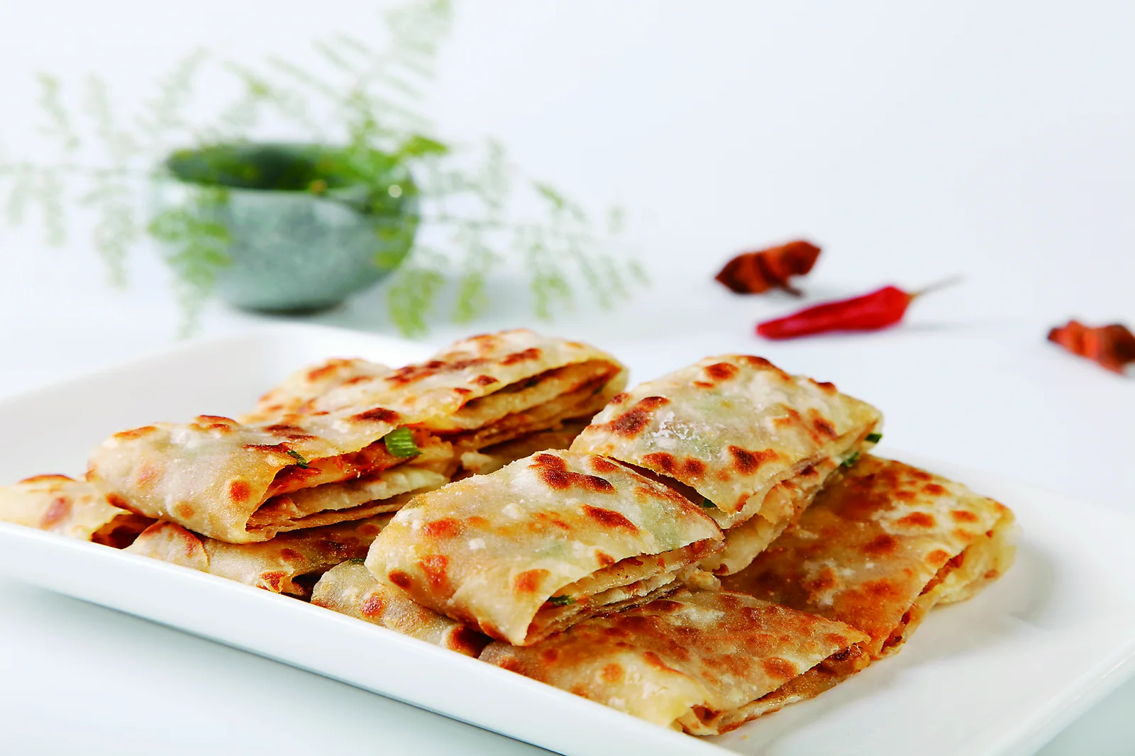 Cut pieces of lamb kangmo showing browned wheat layers and savory filling