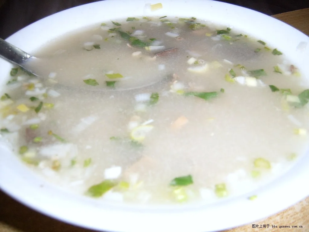 A simple bowl of lamb soup with chopped herbs
