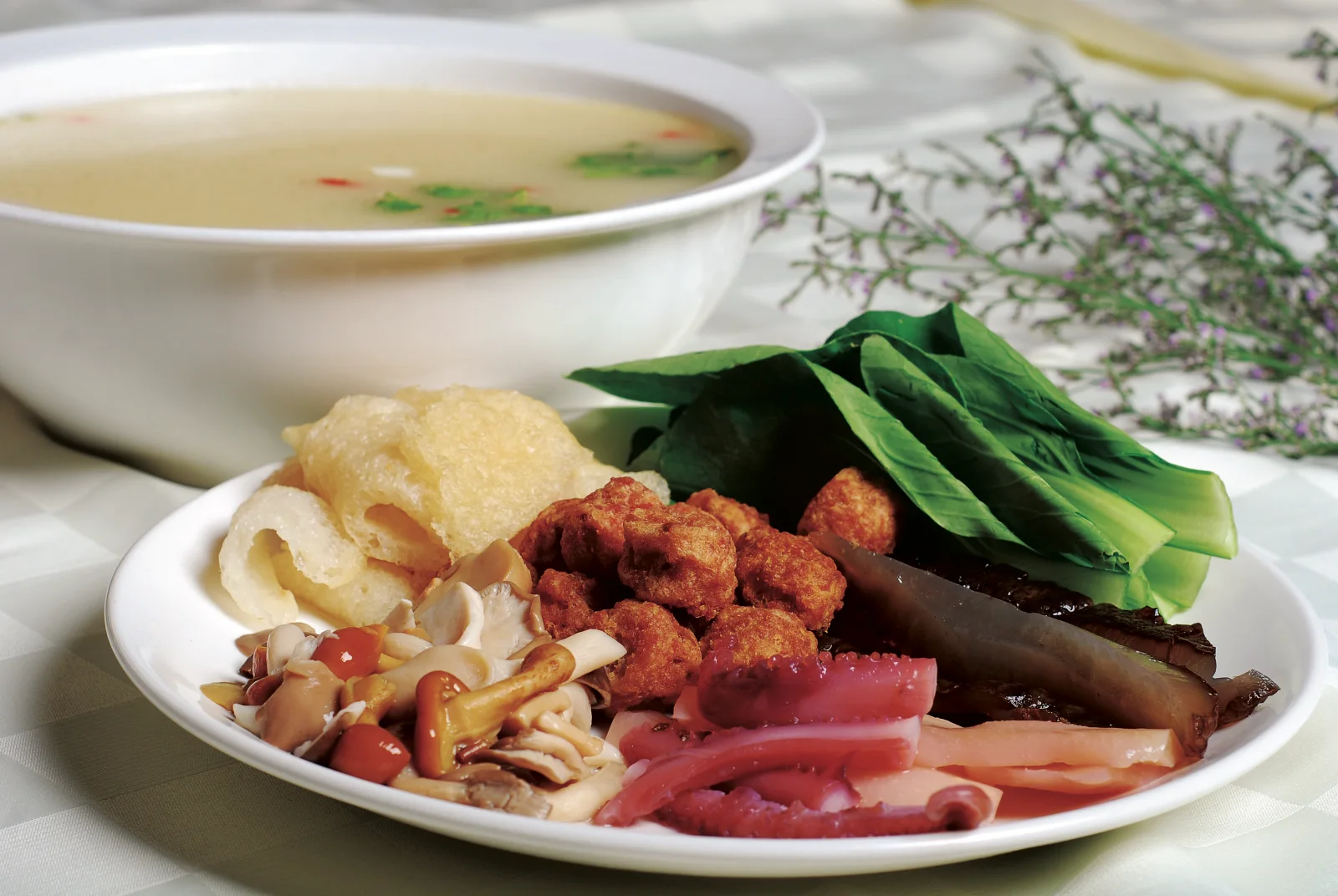 Fried meatballs, vegetables and broth components served as a substantial soup dish