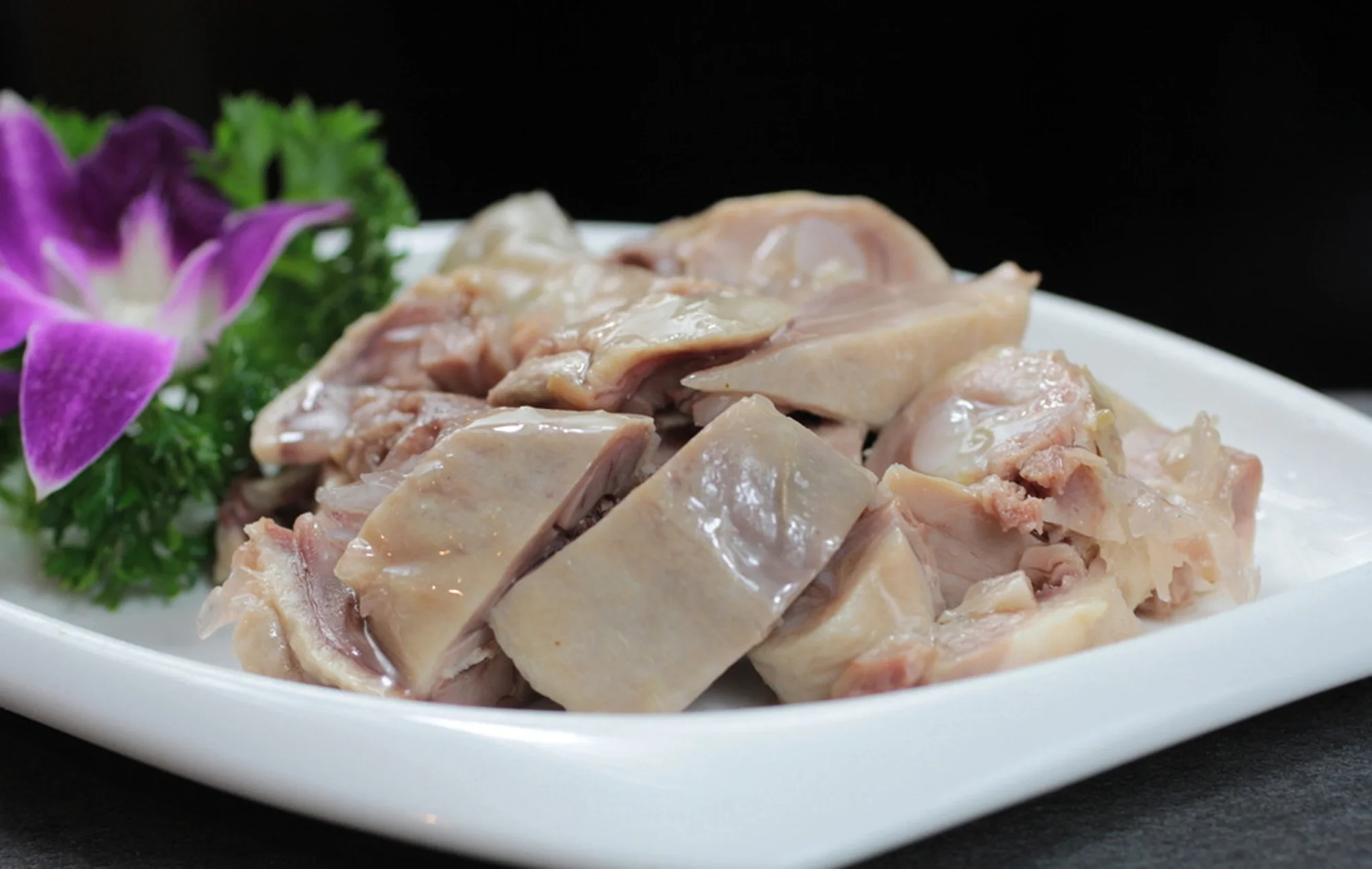 Sliced Nanjing-style saltwater duck arranged on a white plate