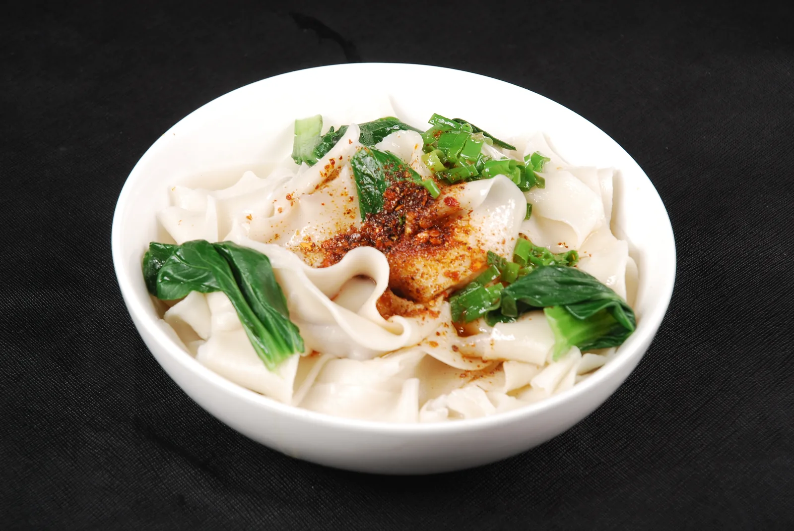 Wide oil-splashed noodles with chile, scallion and greens