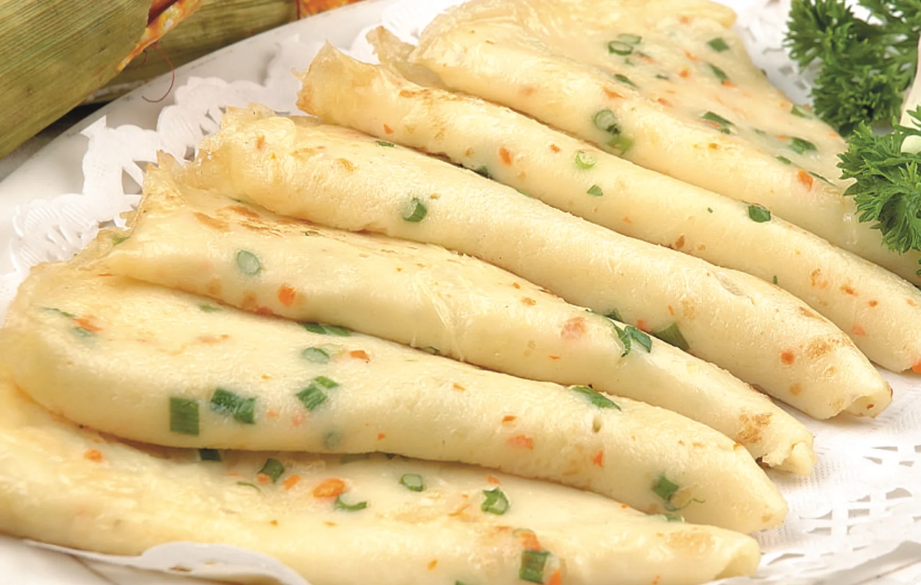 Folded Hangzhou-style savory breakfast pancakes with scallion and small vegetables