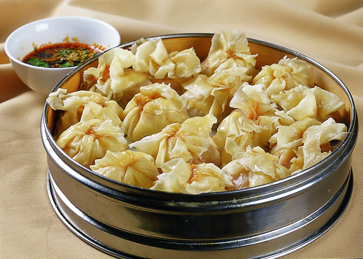 A real regional shaomai basket with loose bunched wrappers that partly close over the filling