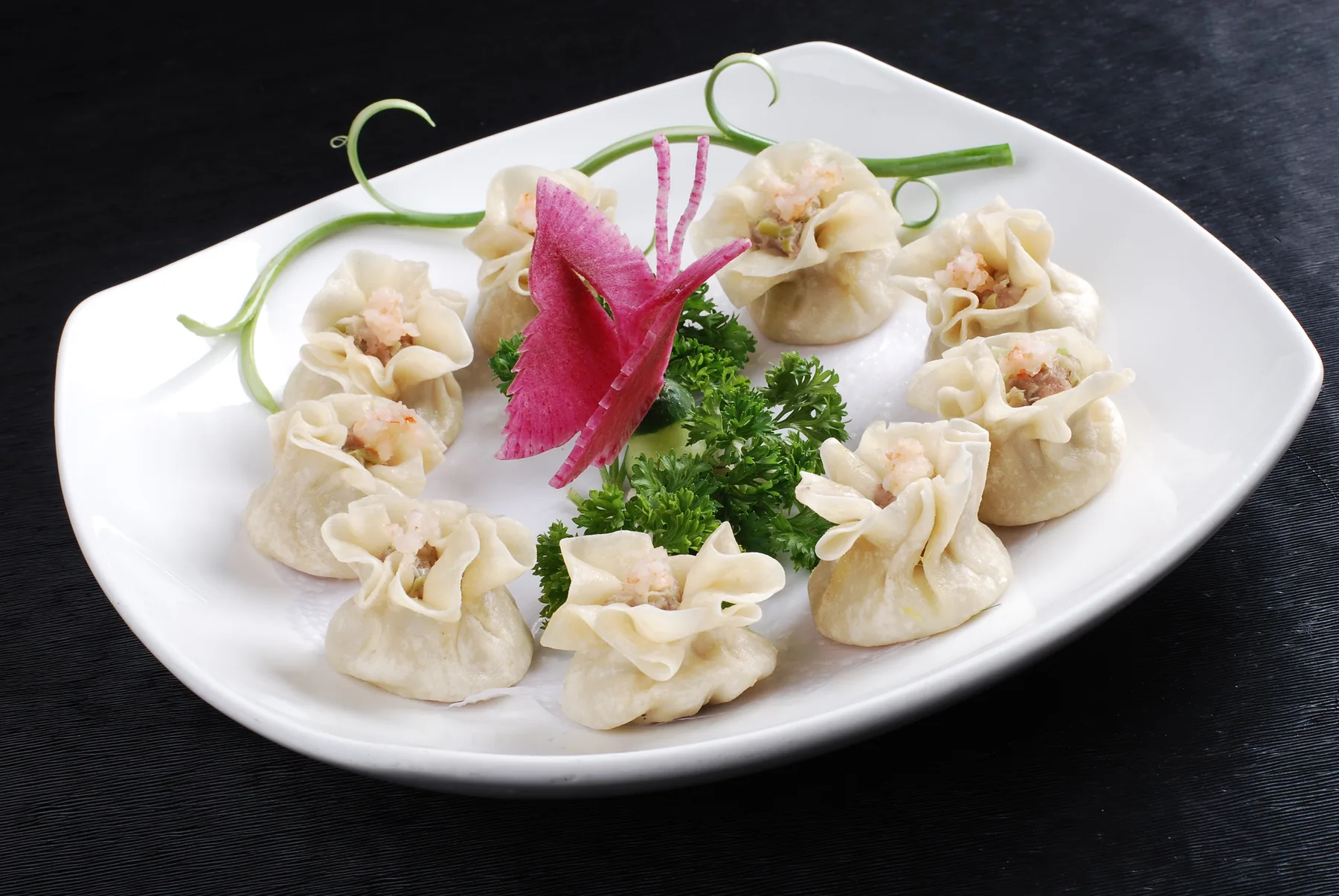 A real regional shrimp shaomai serving with pale flower-like open wrappers and visible topping