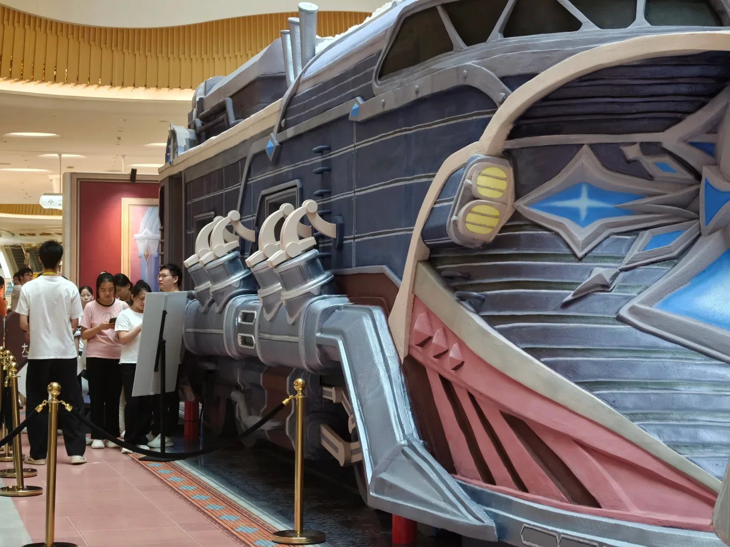 Visitors queue beside a large Genshin Impact installation at a Shenzhen pop-up event