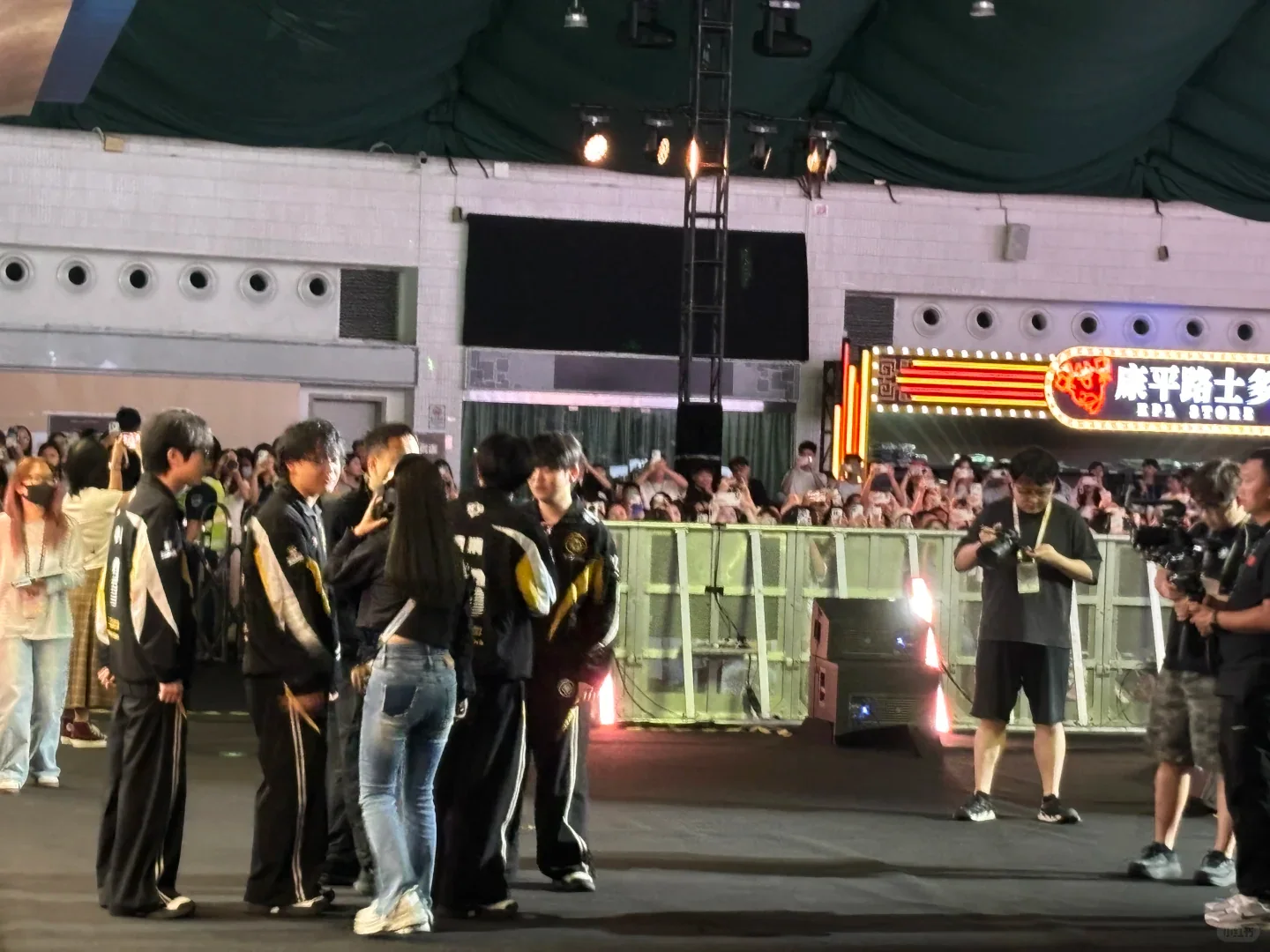 Honor of Kings spectators gathered beside a KPL team walkway inside a Guangzhou arena