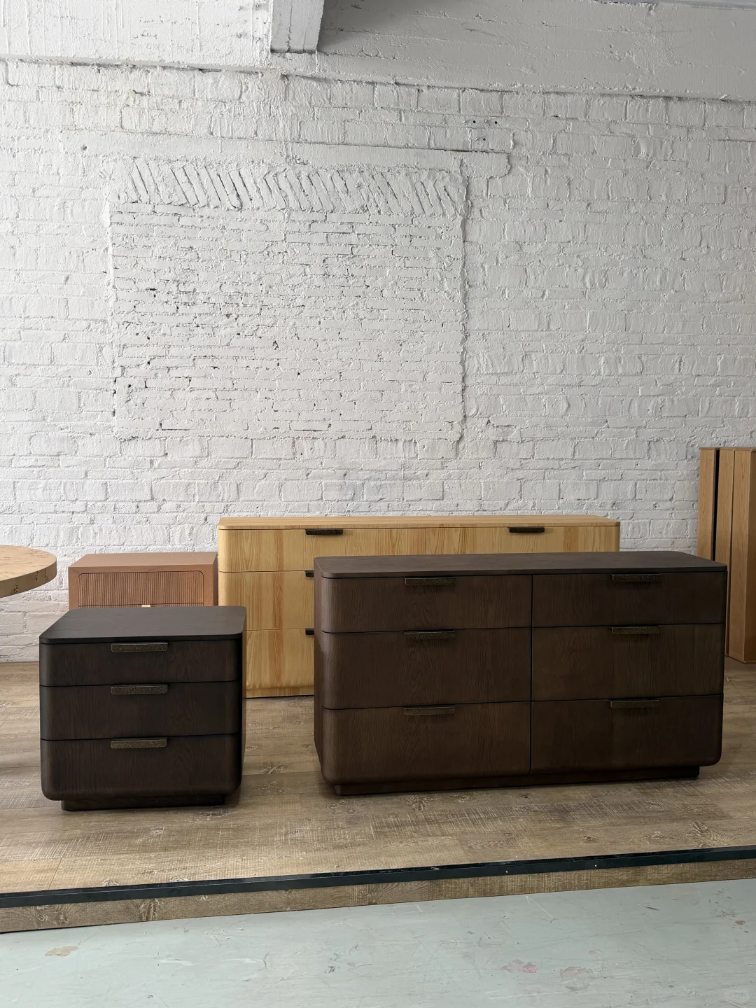 Three drawer cabinets show different finishes, rounded fronts, handle positions and visible alignment gaps