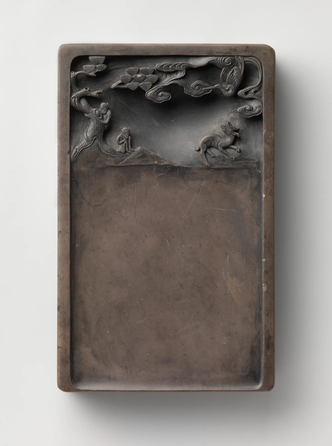 Duan stone inkstone with a plain lower surface beneath a carved scene