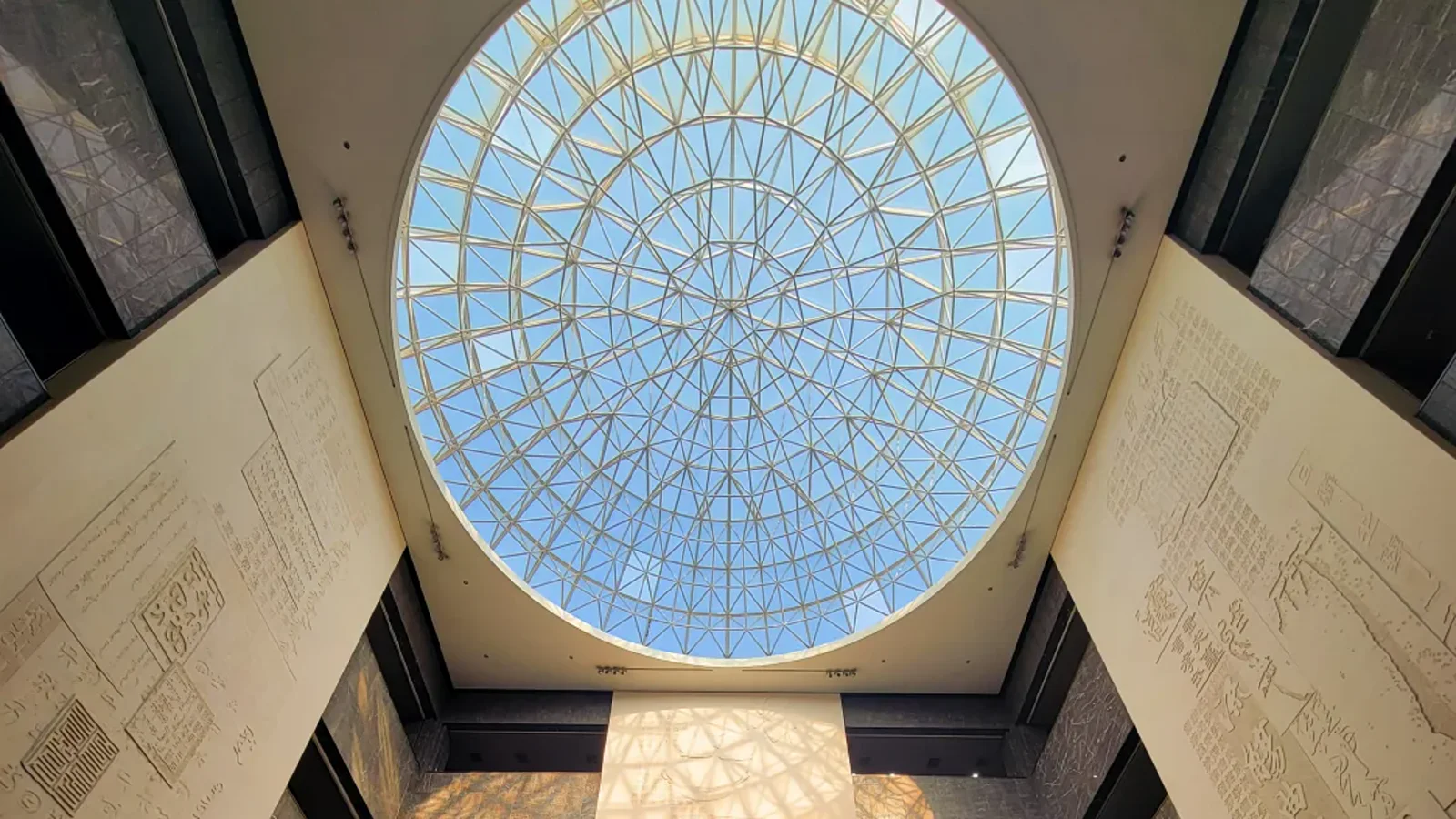 Circular museum dome covered with enlarged Chinese inscriptions above visitors